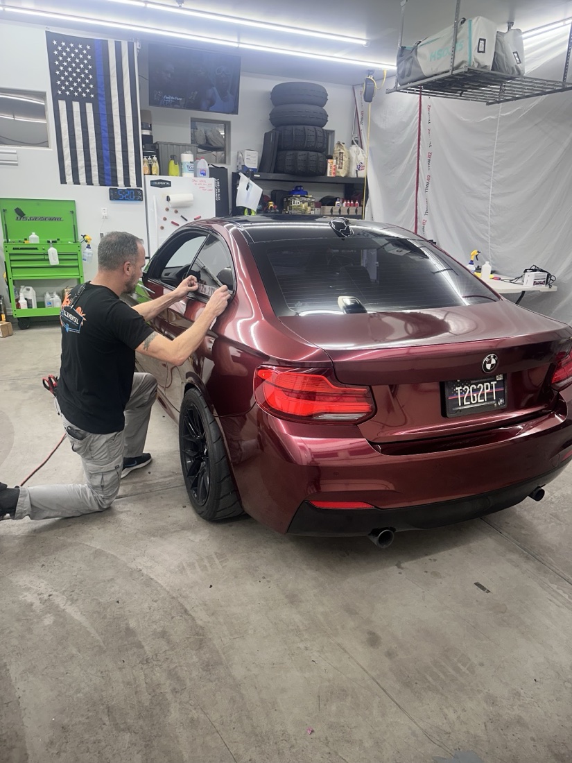 Jason wrapping a customer's BMW in his Goodyear shop